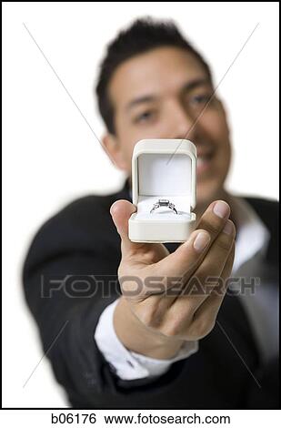 Stock Photograph - Man proposing with an engagement ring. Fotosearch