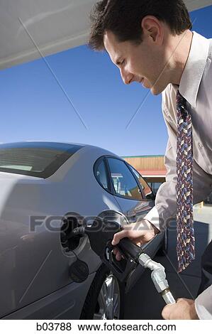 Stock Photo - Man pumping gas. Fotosearch