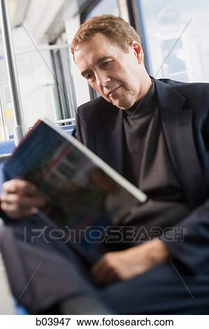 Man reading in bus or subway View Large Photo Image Stock Photo - Man reading in bus or subway. Fotosearch