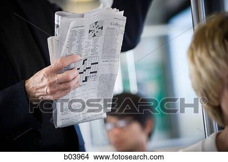 Man reading newspaper on city bus or subway View Large Photo Image Picture - Man reading newspaper on city bus or subway. Fotosearch