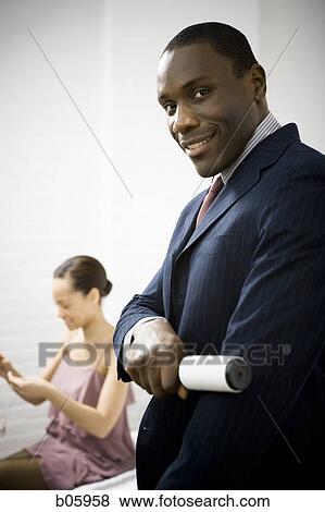 Man rolling lint off his blazer View Large Photo Image Stock Photo - Man rolling lint off his blazer. Fotosearch