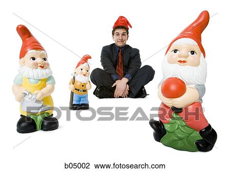 Man sitting cross legged with santa hat and elves View Large Photo Image Stock Image - Man sitting cross legged with santa hat and elves. Fotosearch