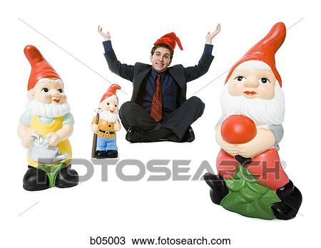 Man sitting cross legged with santa hat and elves View Large Photo Image Stock Image - Man sitting cross legged with santa hat and elves. Fotosearch