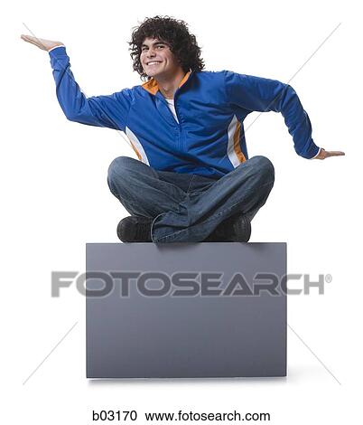 Stock Image - Man sitting on blank sign. Fotosearch