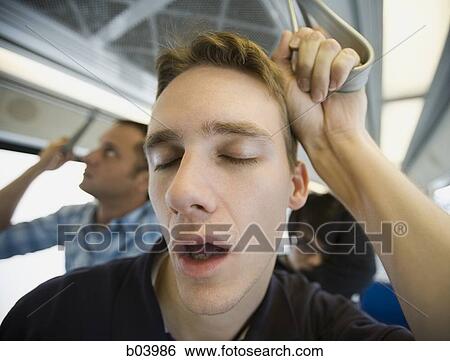 Man sleeping on city bus or subway View Large Photo Image Stock Photograph - Man sleeping on city bus or subway. Fotosearch