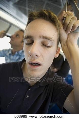 Stock Photography - Man sleeping on city bus or subway. Fotosearch