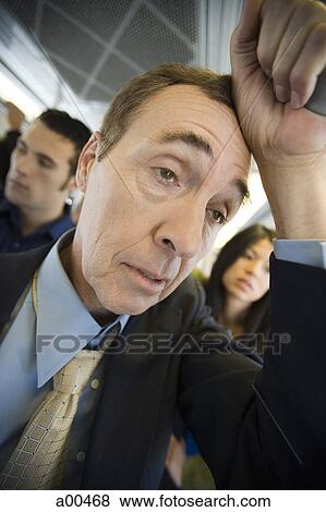 Stock Photo - Man standing on a bus or subway. Fotosearch