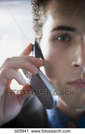 Man talking on cell phone in bus or subway View Large Photo Image Stock Image - Man talking on cell phone in bus or subway. Fotosearch