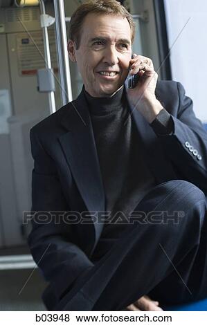 Man talking on cell phone in bus or subway View Large Photo Image Stock Photo - Man talking on cell phone in bus or subway. Fotosearch