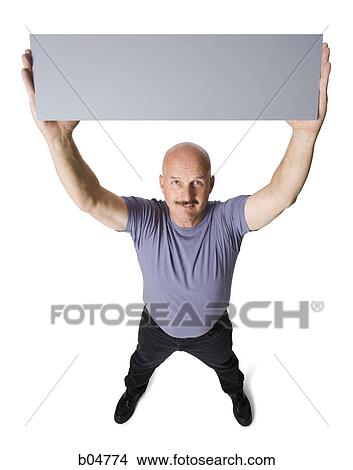 Man with arms up holding blank sign View Large Photo Image Picture - Man with arms up holding blank sign. Fotosearch