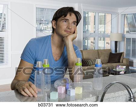 Man with baby bottles and blocks View Large Photo Image Stock Image - Man with baby bottles and blocks. Fotosearch