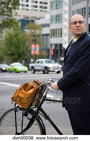 Stock Photo - Man with bicycle and briefcase. Fotosearch