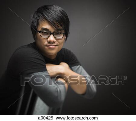 Man with crossed arm on chair View Large Photo Image Stock Photography - Man with crossed arm on chair. Fotosearch