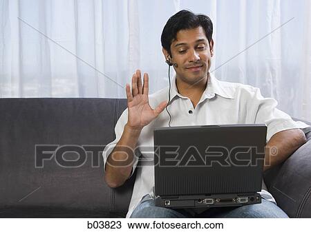 Man with earphone and laptop View Large Photo Image Stock Image - Man with earphone and laptop. Fotosearch