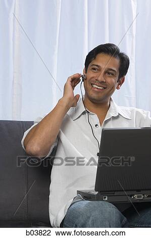Man with earphone listening View Large Photo Image Stock Image - Man with earphone listening. Fotosearch
