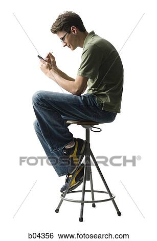Man with electronic organizer on stool View Large Photo Image Stock Photograph - Man with electronic organizer on stool. Fotosearch
