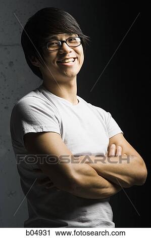 Stock Image - Man with glasses and arms crossed. Fotosearch