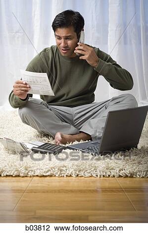Man with laptop talking on phone View Large Photo Image Stock Image - Man with laptop talking on phone. Fotosearch