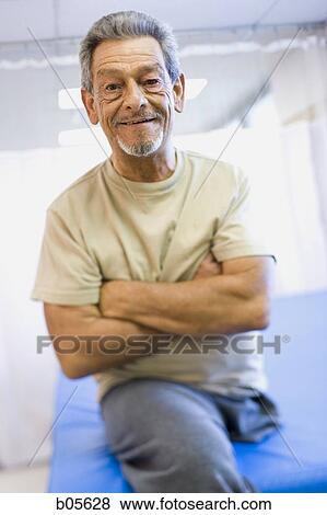Man with one leg sitting with arms crossed View Large Photo Image Stock Photo - Man with one leg sitting with arms crossed. Fotosearch