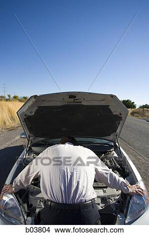 Man with open car engine View Large Photo Image Picture - Man with open car engine. Fotosearch