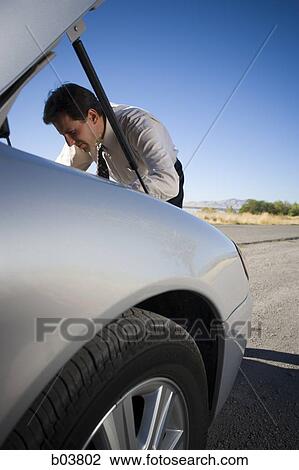 Man with open car engine View Large Photo Image Stock Image - Man with open car engine. Fotosearch