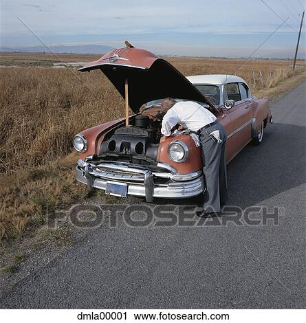 Man with open car engine View Large Photo Image Stock Image - Man with open car engine. Fotosearch