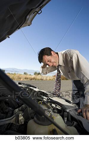 Man with open car engine View Large Photo Image Stock Photography - Man with open car engine. Fotosearch