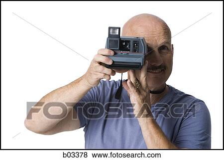 Stock Photo - Man with polaroid camera. Fotosearch