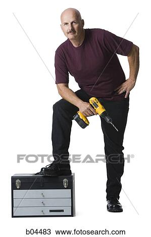 Man with power drill View Large Photo Image Stock Image - Man with power drill. Fotosearch