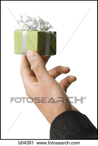 Stock Image - Man with small gift box. Fotosearch