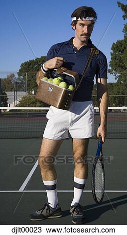 Stock Image - Man with tennis racket and tennis balls. Fotosearch