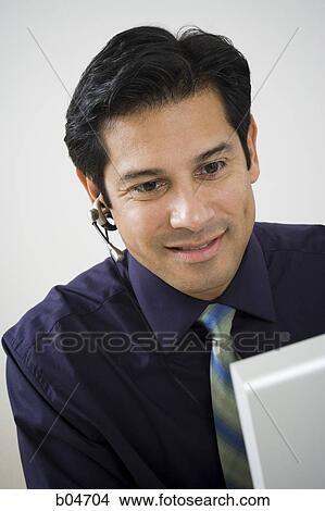 Man working at a computer View Large Photo Image Picture - Man working at a computer. Fotosearch