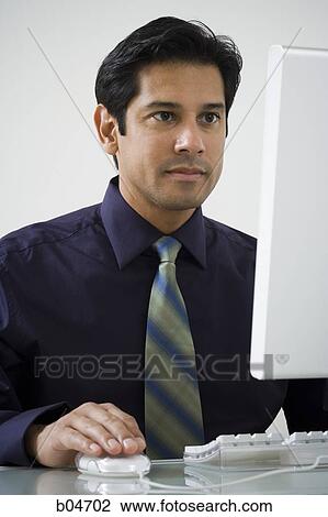 Man working at a computer View Large Photo Image Stock Image - Man working at a computer. Fotosearch
