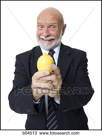 Stock Image - Mature businessman with lemon. Fotosearch