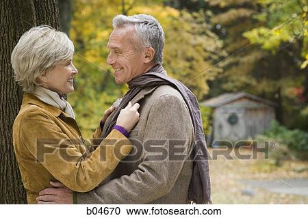 Mature couple embracing outdoors View Large Photo Image Stock Image - Mature couple embracing outdoors. Fotosearch