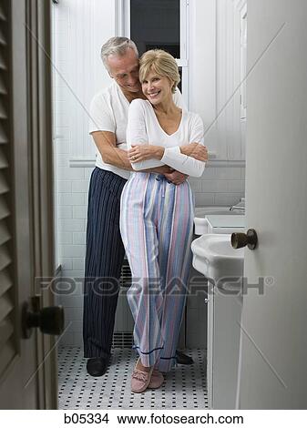 Picture - Mature couple in bathroom embracing. Fotosearch