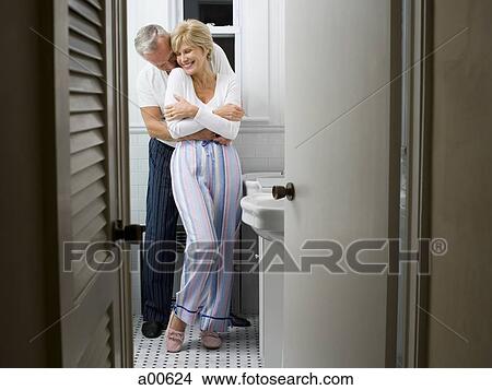 Mature couple in bathroom hugging View Large Photo Image Picture - Mature couple in bathroom hugging. Fotosearch