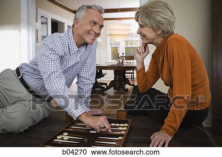 Mature couple playing backgammon View Large Photo Image Stock Image - Mature couple playing backgammon. Fotosearch