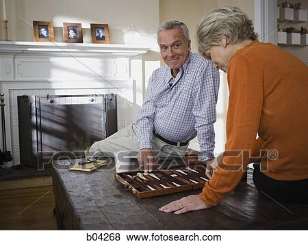 Mature couple playing backgammon View Large Photo Image Stock Photo - Mature couple playing backgammon. Fotosearch