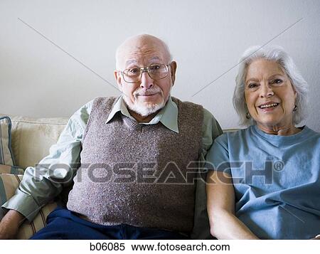 Stock Photography - Mature couple sitting on the couch. Fotosearch
