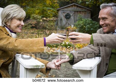Mature couple toasting outdoors View Large Photo Image Stock Image - Mature couple toasting outdoors. Fotosearch