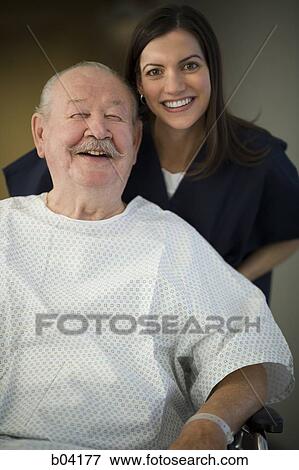 Mature man in hospital gown with nurse smiling View Large Photo Image Stock Photo - Mature man in hospital gown with nurse smiling. Fotosearch