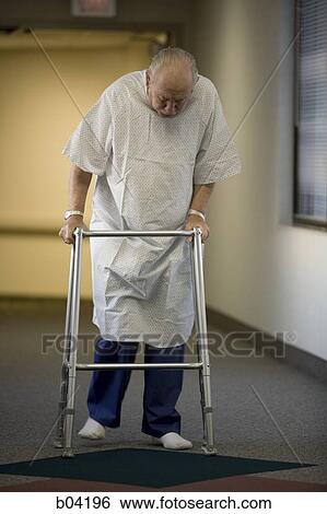 Mature man in hospital gown with walker View Large Photo Image Stock Photograph - Mature man in hospital gown with walker. Fotosearch