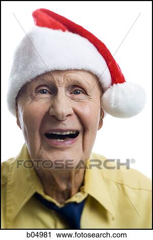 Stock Image - Mature man in santa hat. Fotosearch