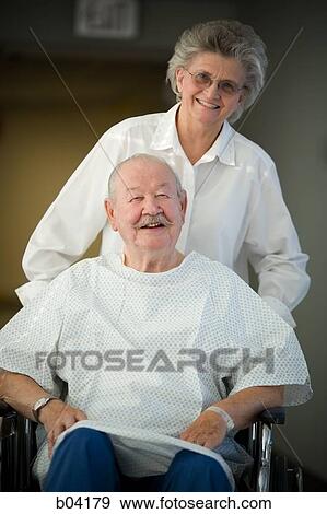Mature man in wheelchair with mature woman View Large Photo Image Stock Photo - Mature man in wheelchair with mature woman. Fotosearch