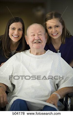 Mature man in wheelchair with nurses smiling View Large Photo Image Stock Photo - Mature man in wheelchair with nurses smiling. Fotosearch