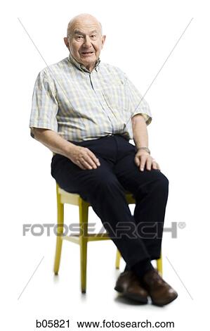 Mature man sitting in a chair View Large Photo Image Stock Image - Mature man sitting in a chair. Fotosearch