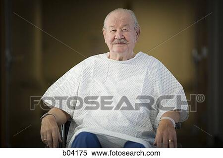 Stock Photography - Mature man sitting in wheelchair. Fotosearch