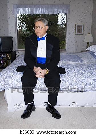 Mature man sitting on a bed View Large Photo Image Stock Photo - Mature man sitting on a bed. Fotosearch