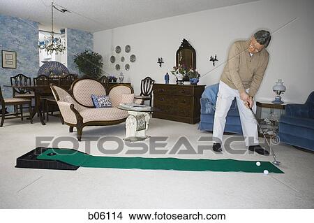 Mature man using a putting set View Large Photo Image Picture - Mature man using a putting set. Fotosearch